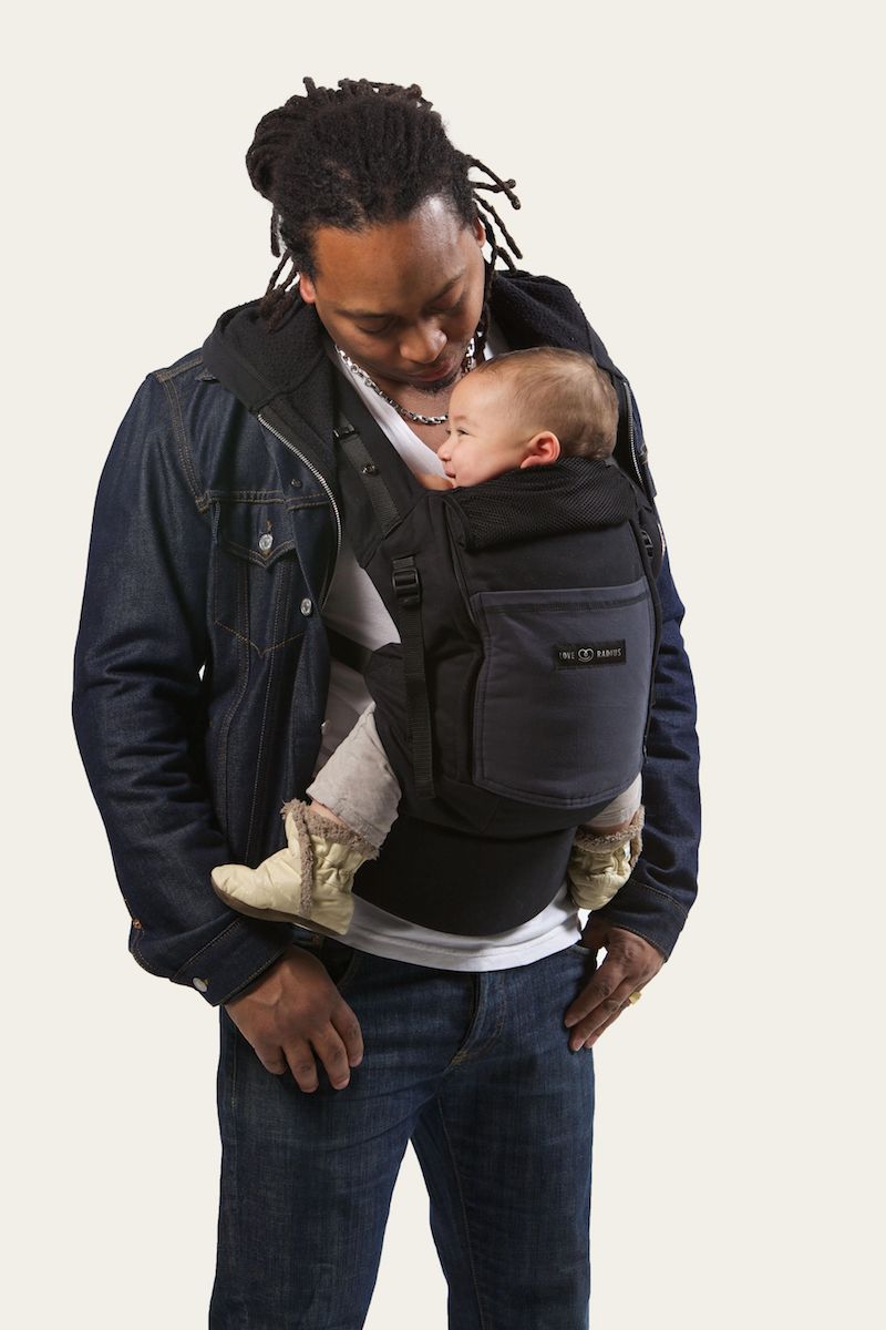 Dad babywearing his baby in an ergonomic carrier the PhysioCarrier